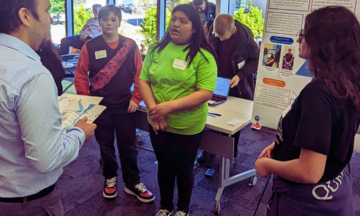 Middle school students talking about their research to competition judge